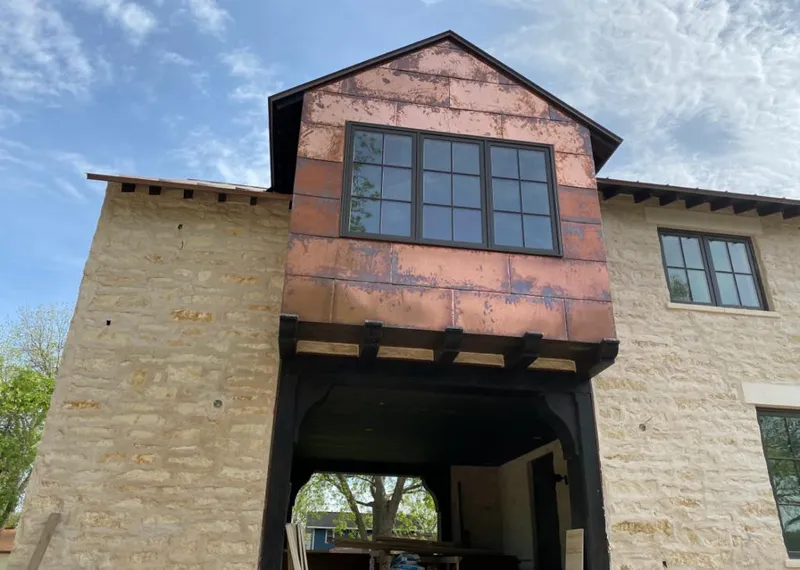 Copper metal panel facade on a stone building for Skylight Installation in Orlovista