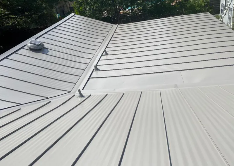Solar attic fan installed on a metal roof for Roof Ventilation in Orlovista
