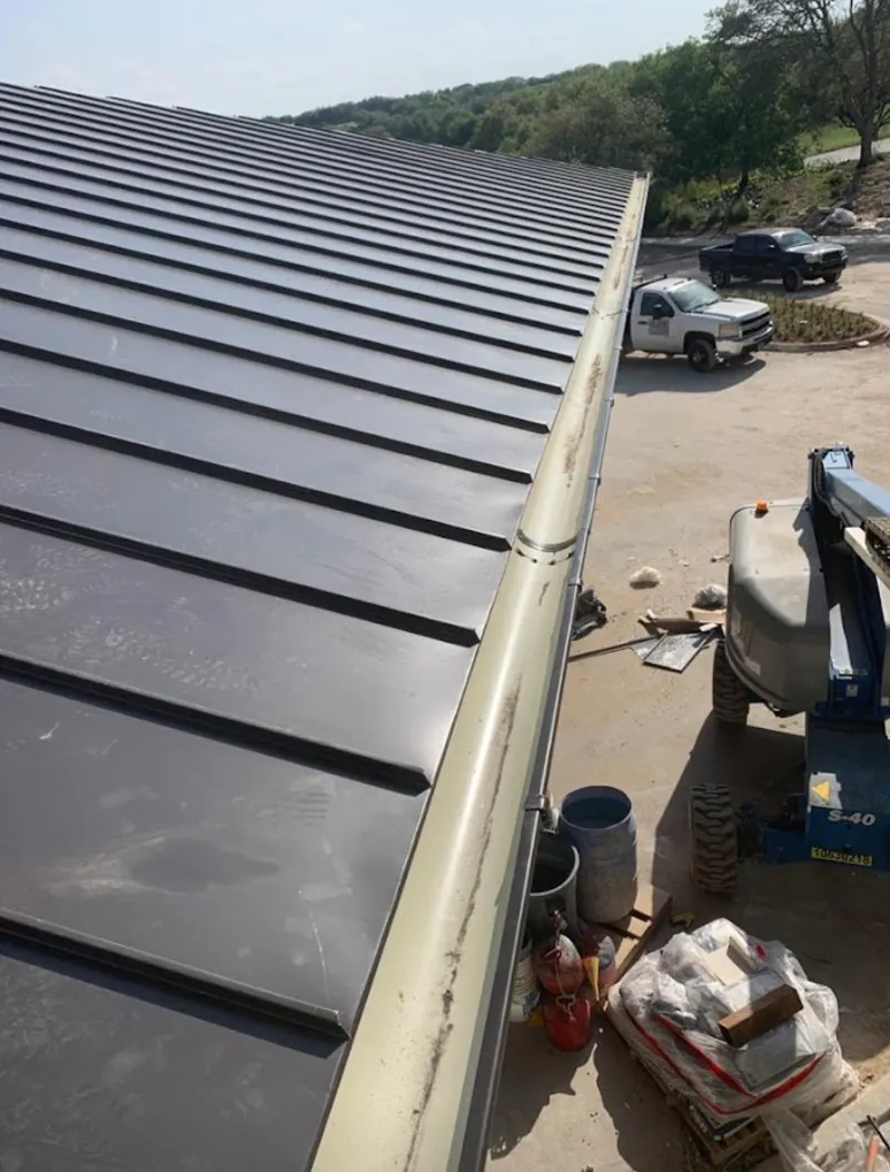 Standing seam panel and gutter detail on a metal roofing jobsite in Orlovista